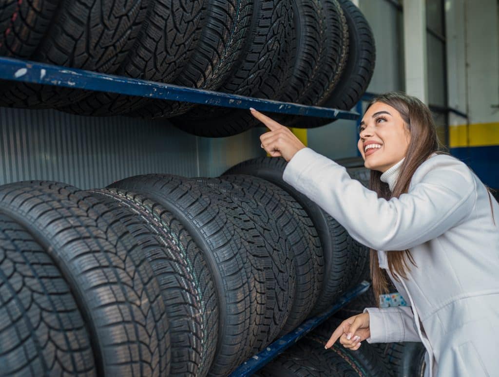 A female looking at the tires in the garage